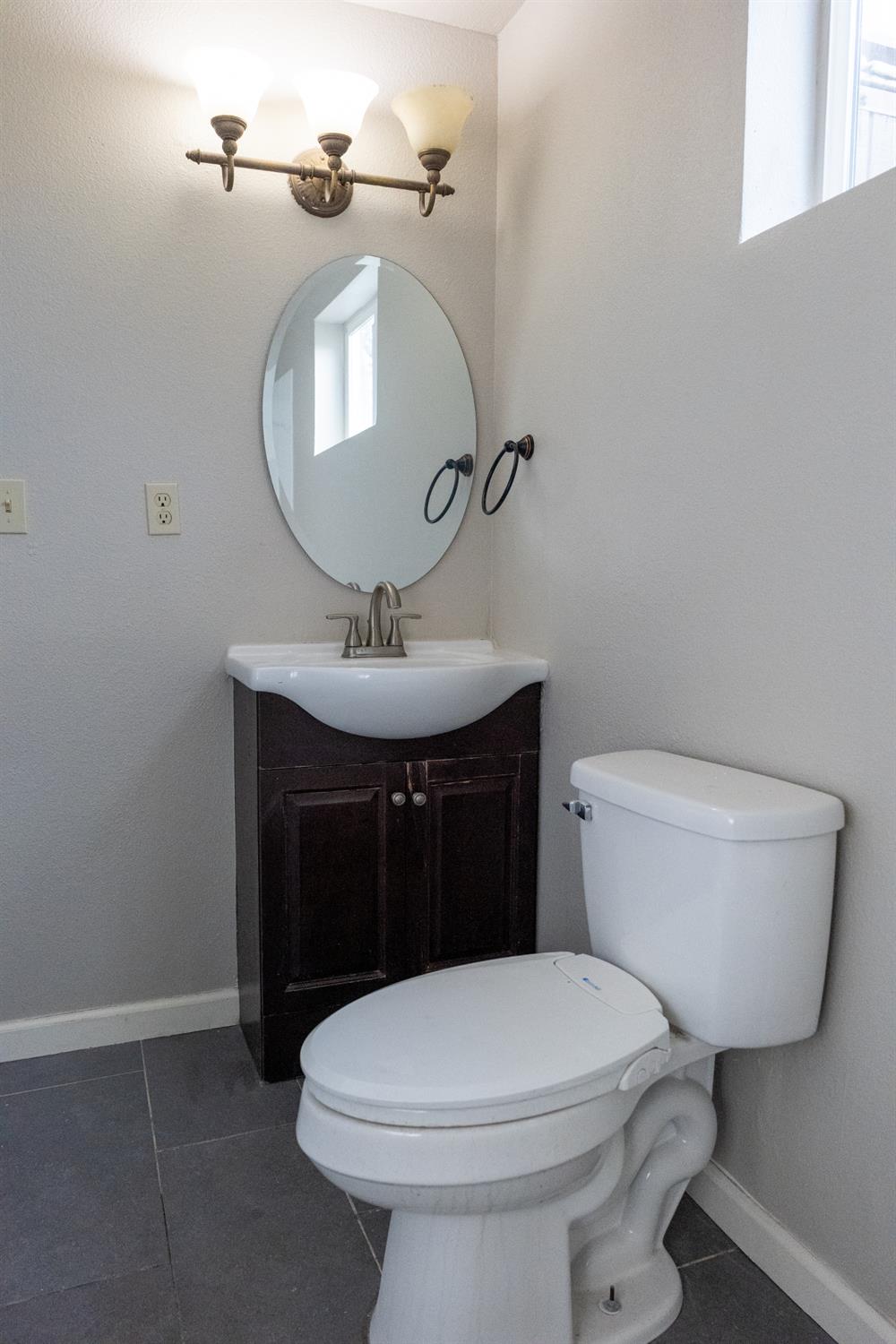 42560 Ranger Cir Way Coarsegold, CA 93614 - Photo 27 of 44 a bathroom with a toilet sink and mirror