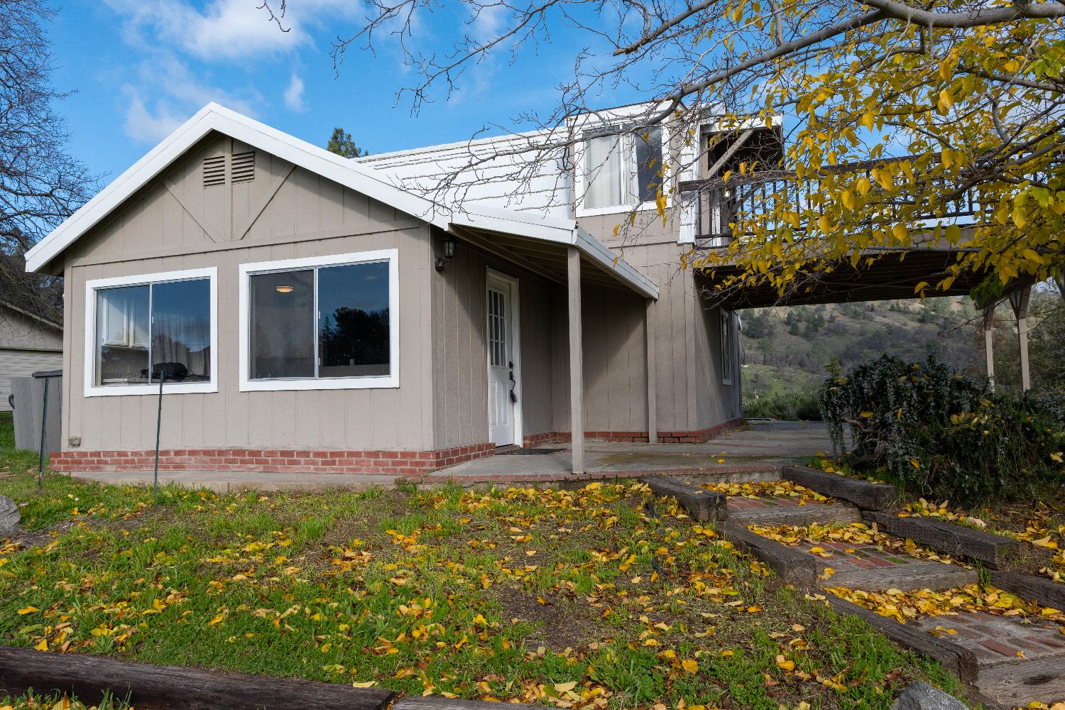 42560 Ranger Cir Way Coarsegold, CA 93614 - Photo 6 of 44 a front view of a house with a garden