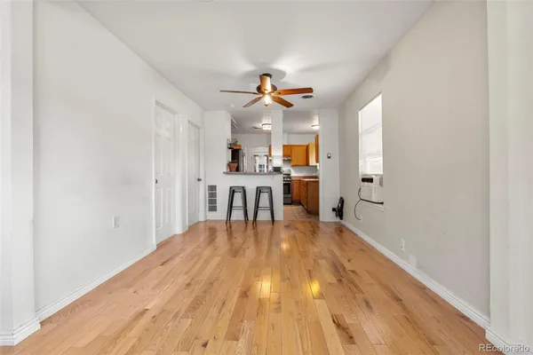 a view of a kitchen with wooden floor and a kitchen