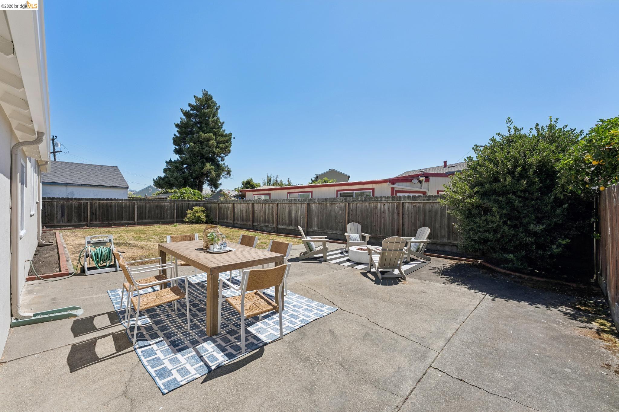 15162 Inverness Street San Leandro, CA 94579 - Photo 18 of 25 Spacious backyard featuring a concrete patio, wood fencing, and a generous grass area
