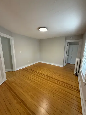 a view of a room with wooden floor