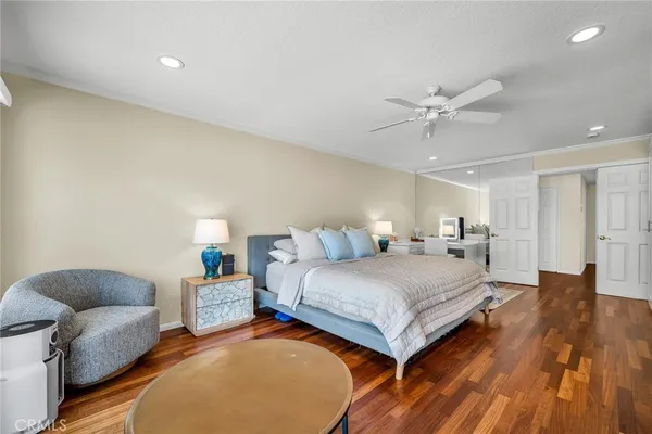 a spacious bedroom with a bed and a couch