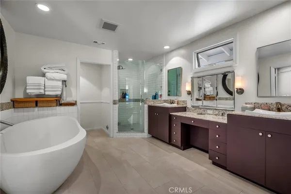 a large bathroom with a large tub sink and vanity