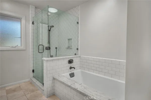 a bathroom with a tub a sink and shower