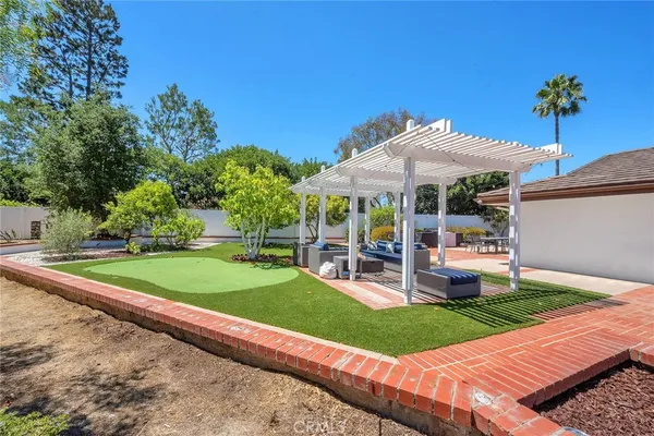 a view of a patio with a table and chairs under an umbrella
