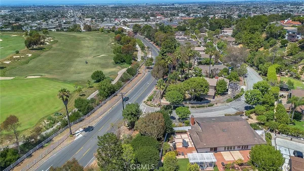 an aerial view of residential houses with outdoor space and river