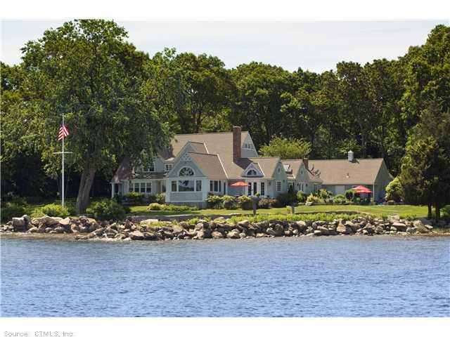 a view of a large house with a yard and large trees