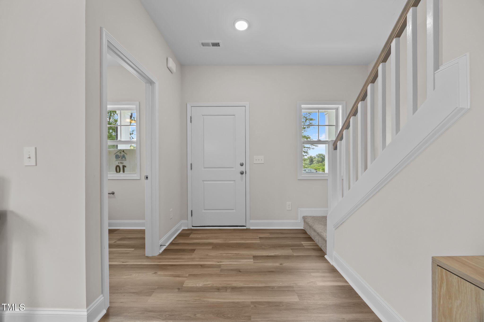 187 Regis Lane, Unit 10 Coats, NC 27521 - Photo 16 of 38 a view of a hallway with wooden floor and entryway
