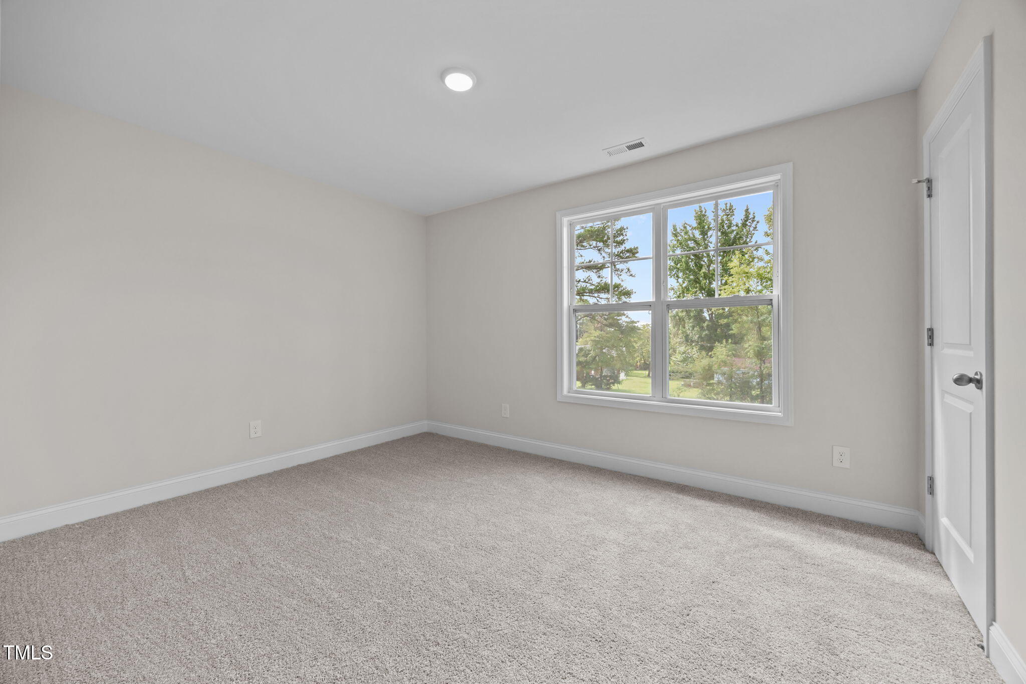 187 Regis Lane, Unit 10 Coats, NC 27521 - Photo 17 of 38 an empty room with a window