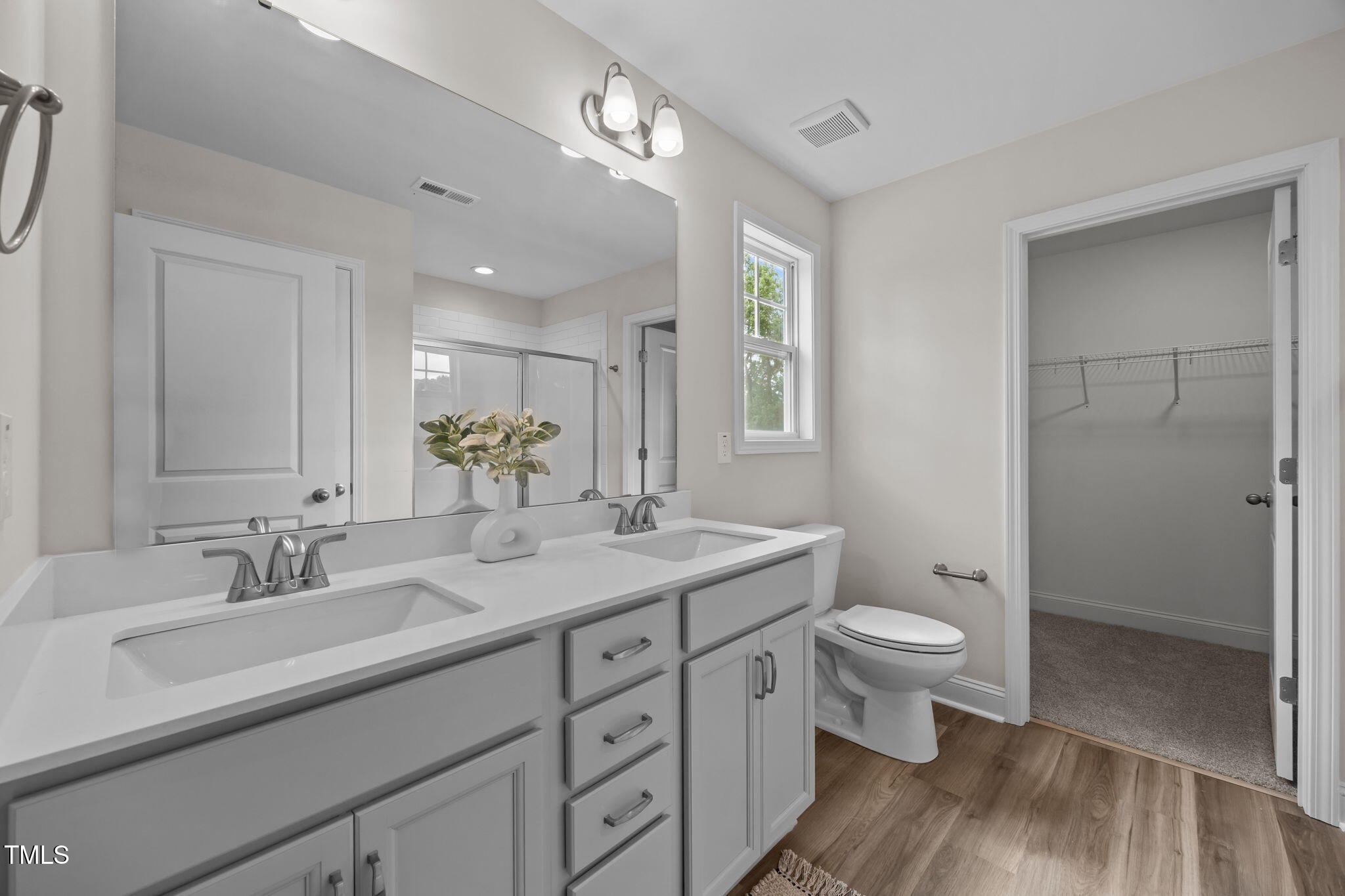 187 Regis Lane, Unit 10 Coats, NC 27521 - Photo 22 of 38 a bathroom with a double vanity sink toilet and shower
