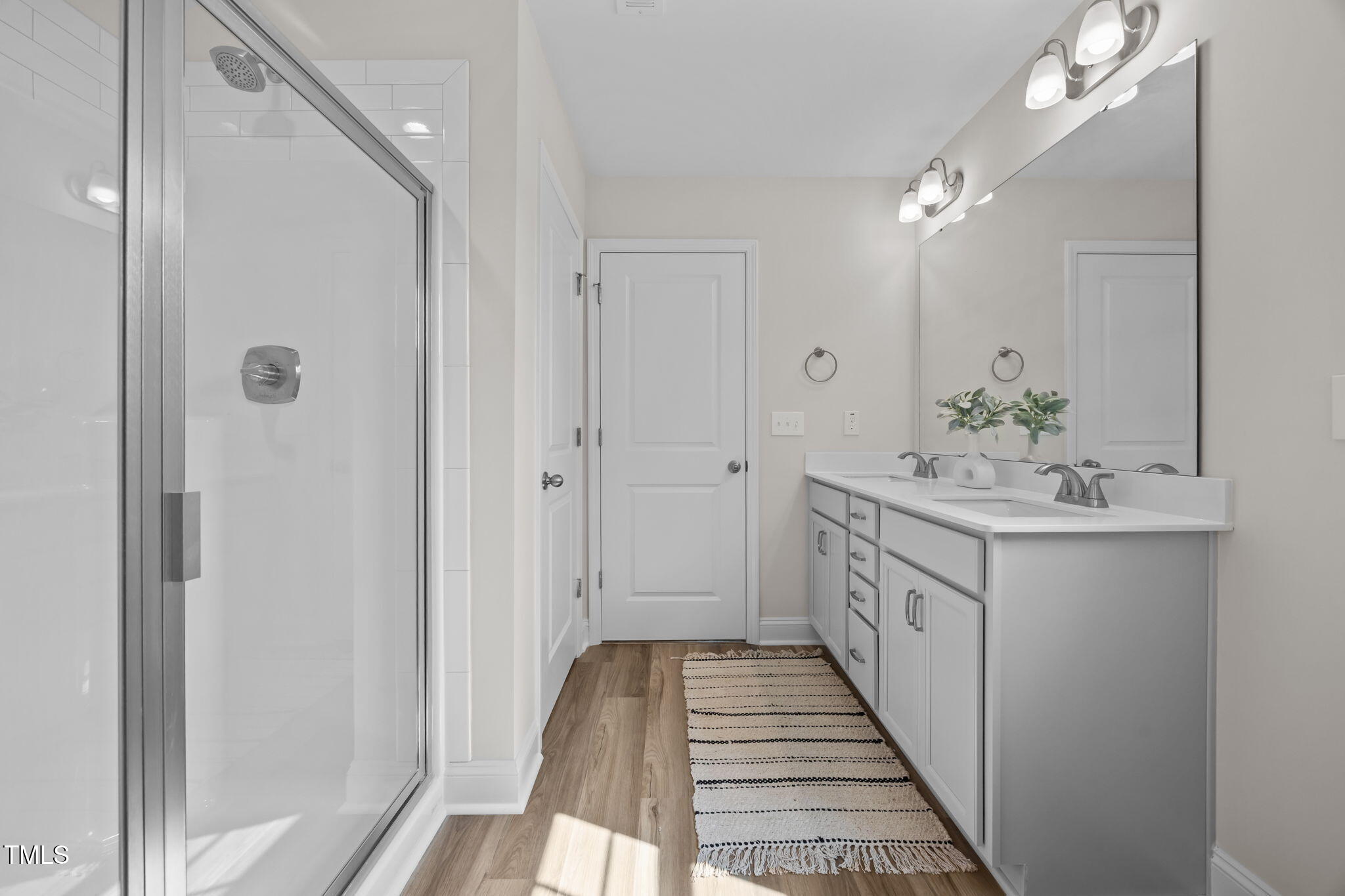 187 Regis Lane, Unit 10 Coats, NC 27521 - Photo 25 of 38 a bathroom with a double vanity sink and a mirror