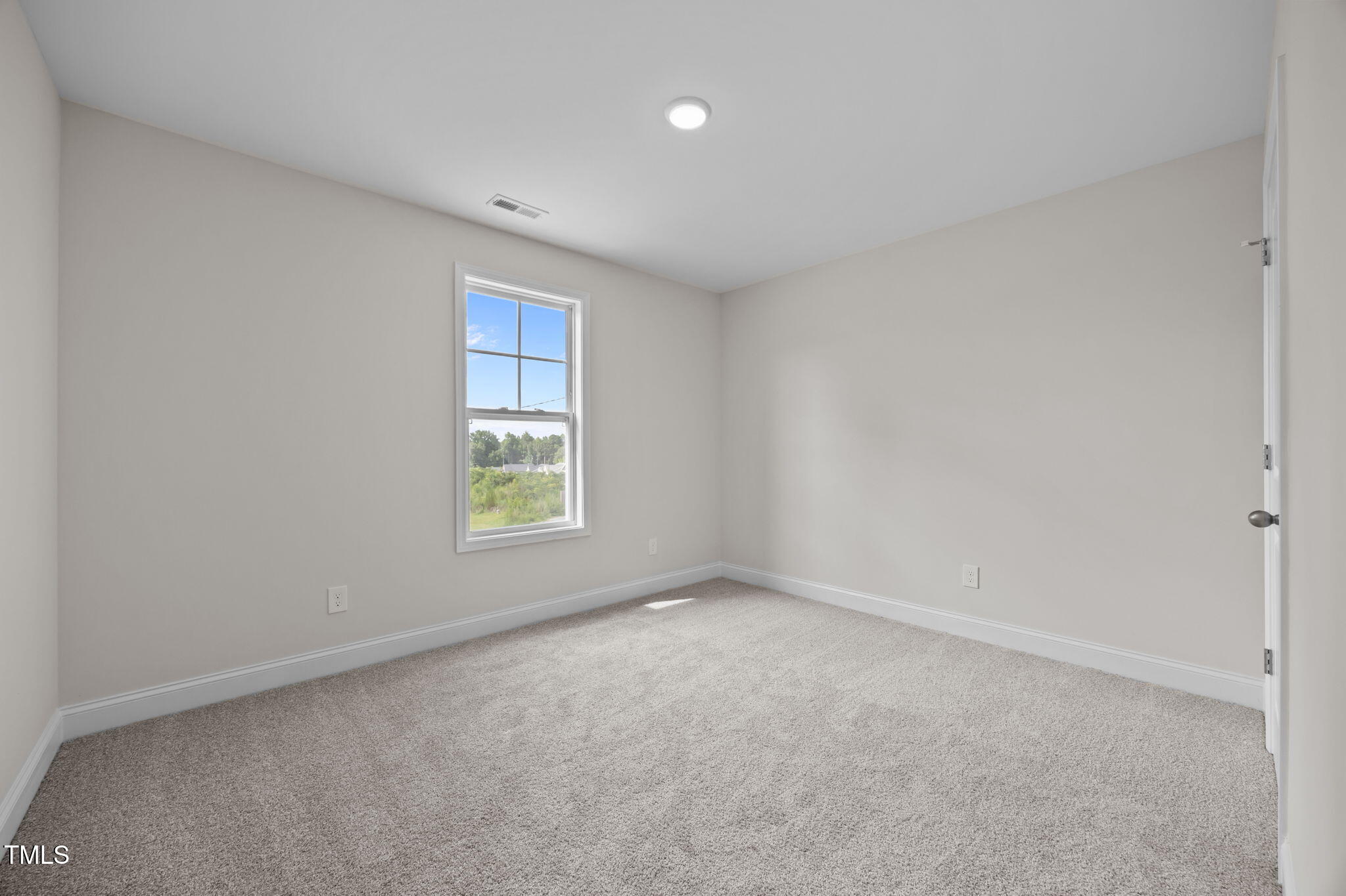 187 Regis Lane, Unit 10 Coats, NC 27521 - Photo 26 of 38 a view of an empty room with a window