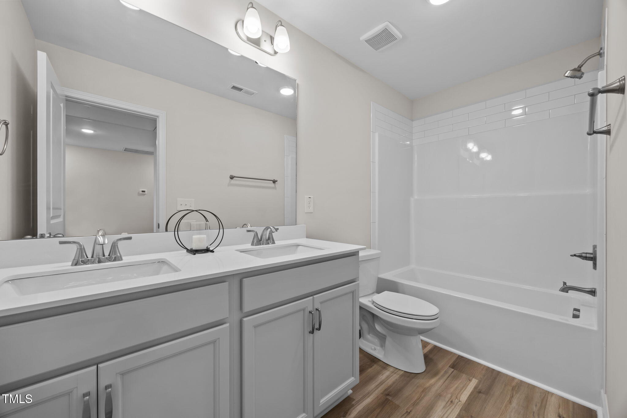 187 Regis Lane, Unit 10 Coats, NC 27521 - Photo 28 of 38 a bathroom with a granite countertop sink a toilet and shower