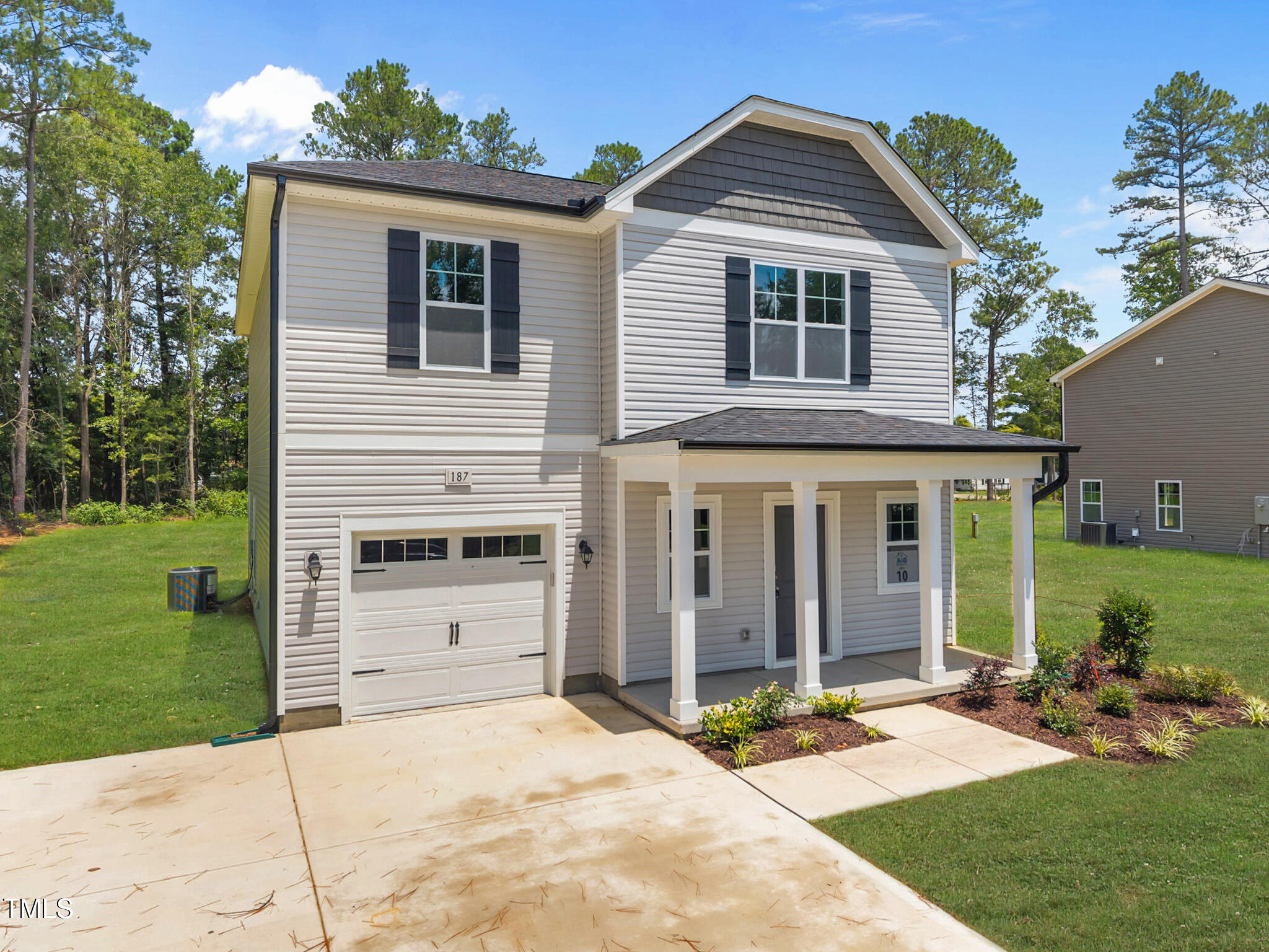 187 Regis Lane, Unit 10 Coats, NC 27521 - Photo 30 of 38 a front view of a house with a yard