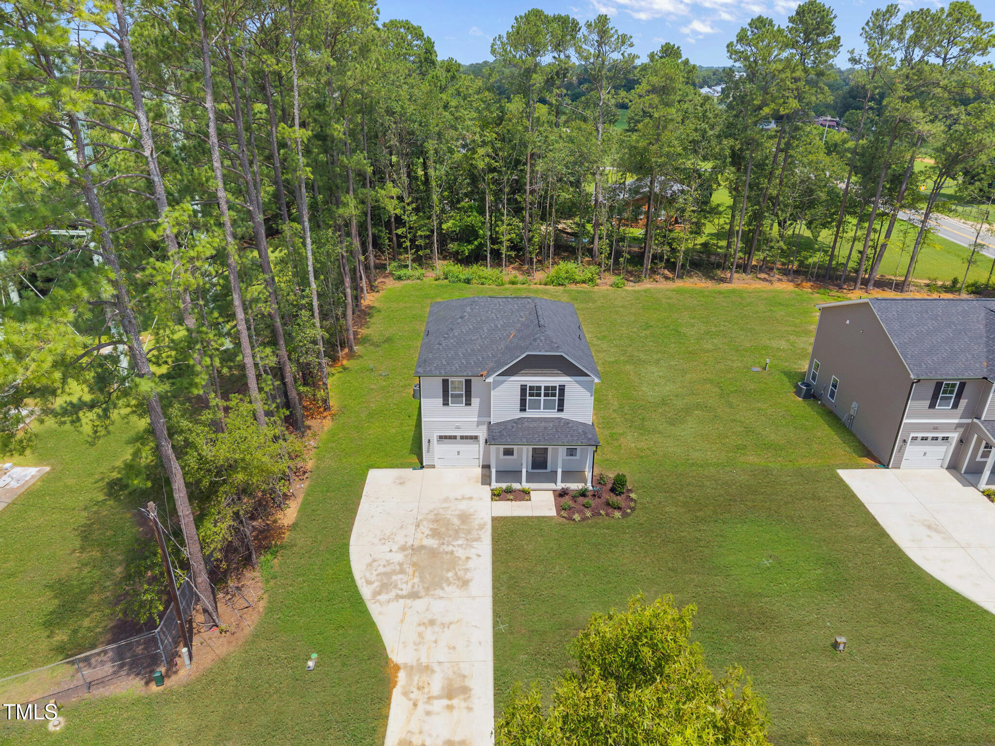 187 Regis Lane, Unit 10 Coats, NC 27521 - Photo 33 of 38 an aerial view of a house with a garden