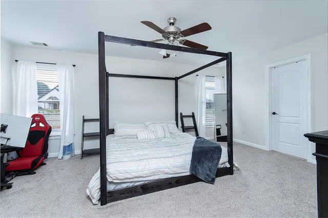 a bedroom with bed and window