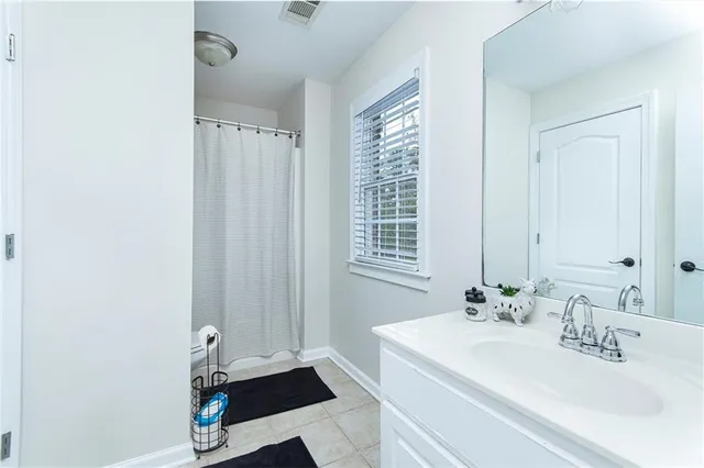 a bathroom with a sink a mirror and a window