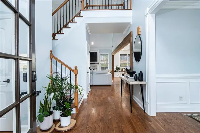 a view of entryway and hall with wooden floor