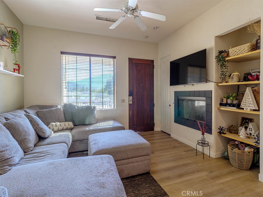50680 Santa Rosa Plaza, Unit 8 La Quinta, CA 92253 - Photo 4 of 20 a living room with furniture and a flat screen tv