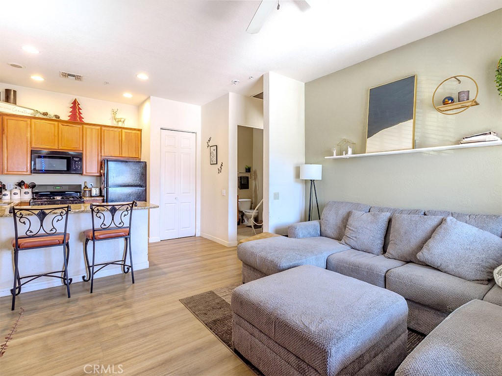 50680 Santa Rosa Plaza, Unit 8 La Quinta, CA 92253 - Photo 5 of 20 a living room with furniture and kitchen view