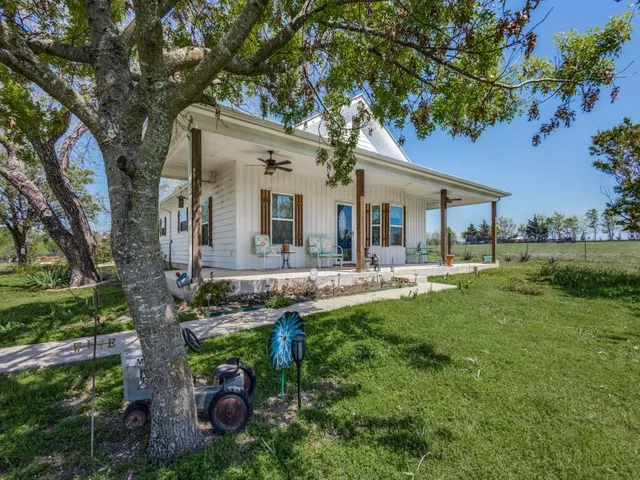 a front view of house with yard and outdoor seating