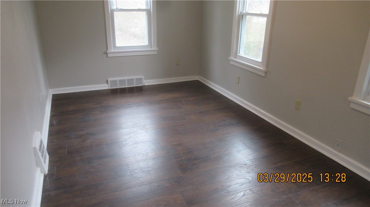 36505 Pettibone Road Solon, OH 44139 - Photo 15 of 24 Unfurnished room with dark wood-style floors, baseboards, and visible vents