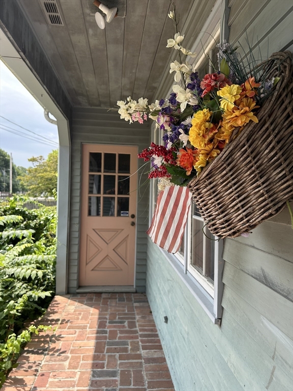 273 Main Street Acushnet, MA 02743 - Photo 9 of 37 a view of a entryway door with flower in front of it