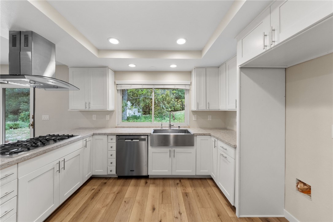 665 Norwynn Lane Fallbrook, CA 92028 - Photo 12 of 51 a kitchen with a white cabinets a sink and wooden floor