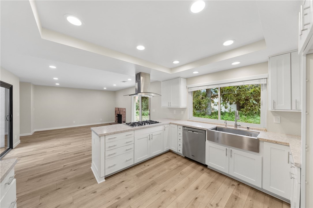 665 Norwynn Lane Fallbrook, CA 92028 - Photo 13 of 51 a kitchen with white cabinets and wooden floors