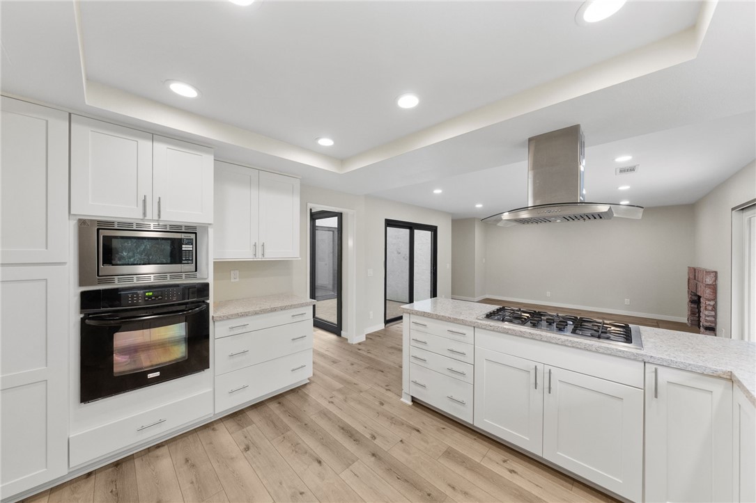 665 Norwynn Lane Fallbrook, CA 92028 - Photo 14 of 51 a kitchen with stainless steel appliances white cabinets and stove