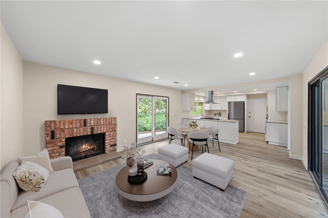 665 Norwynn Lane Fallbrook, CA 92028 - Photo 18 of 51 a living room with furniture flat screen tv and a fireplace