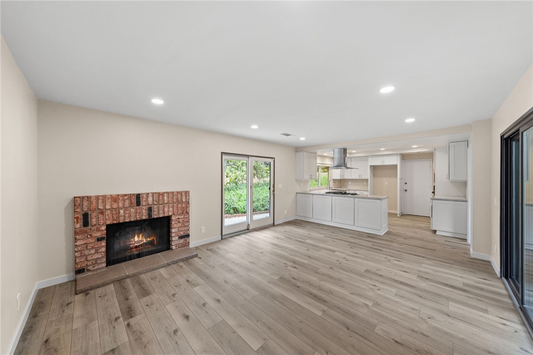 665 Norwynn Lane Fallbrook, CA 92028 - Photo 19 of 51 a view of an empty room with a fireplace and a window