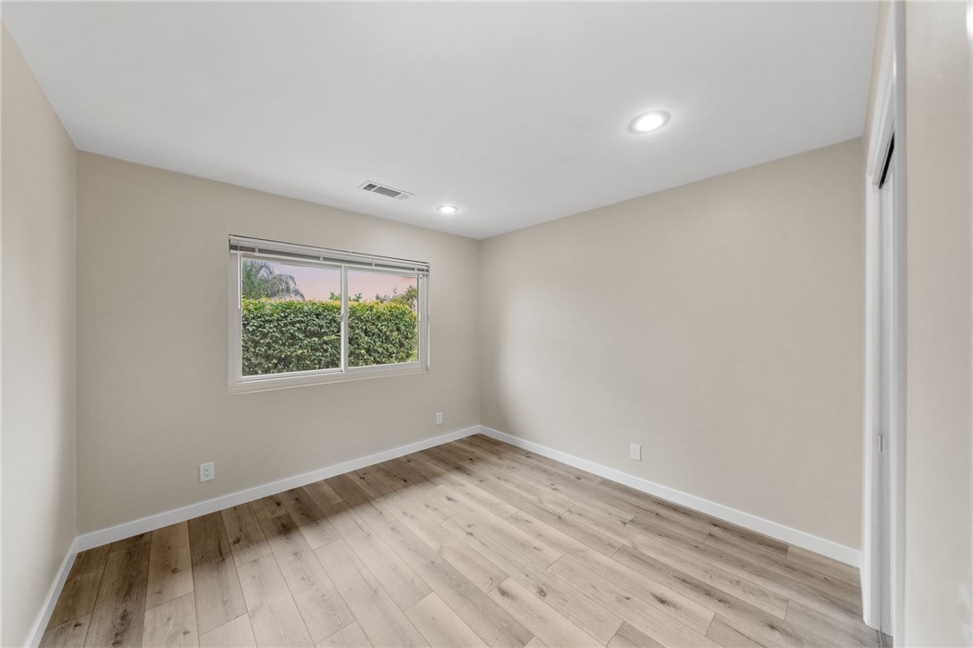 665 Norwynn Lane Fallbrook, CA 92028 - Photo 25 of 51 a view of an empty room with wooden floor and a window