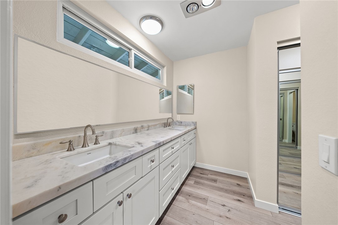 665 Norwynn Lane Fallbrook, CA 92028 - Photo 28 of 51 a bathroom with a granite countertop double vanity and a mirror