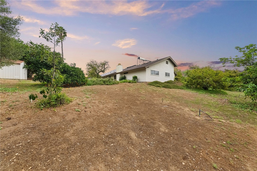 665 Norwynn Lane Fallbrook, CA 92028 - Photo 32 of 51 a view of a house with a yard and large trees