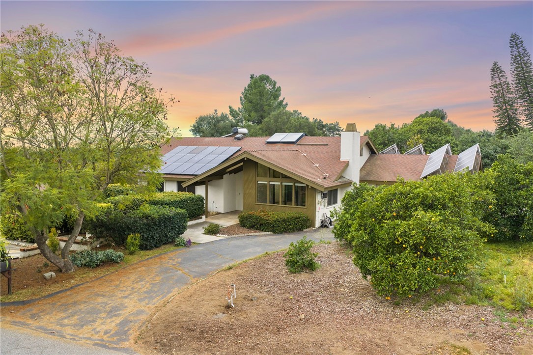 665 Norwynn Lane Fallbrook, CA 92028 - Photo 51 of 51 a view of a house with a small yard and large tree