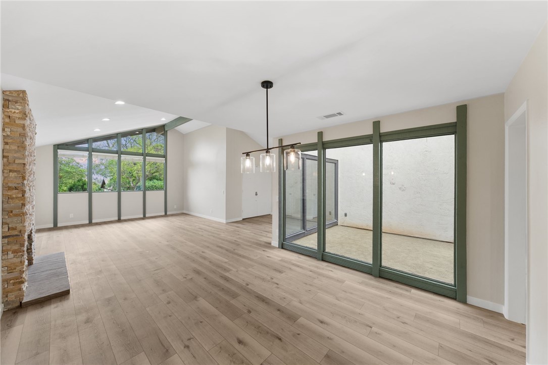 665 Norwynn Lane Fallbrook, CA 92028 - Photo 6 of 51 a view of an empty room with wooden floor and a window