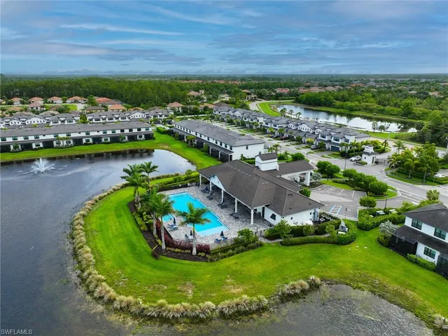 an aerial view of a house with a garden and lake view