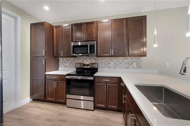 a kitchen with stainless steel appliances wooden cabinets and stove