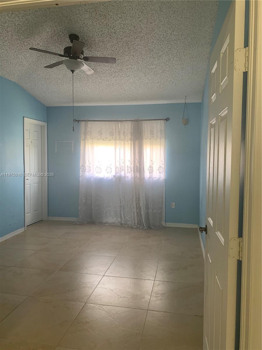 2211 Southeast 23rd Road, Unit 2211 Homestead, FL 33035 - Photo 16 of 39 a view of an empty room with a window