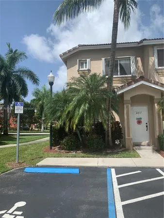 a view of a house with a yard and a large window