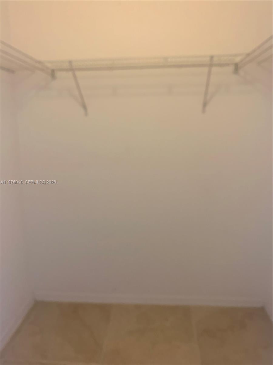 2211 Southeast 23rd Road, Unit 2211 Homestead, FL 33035 - Photo 23 of 39 a view of a room with racks on the wall