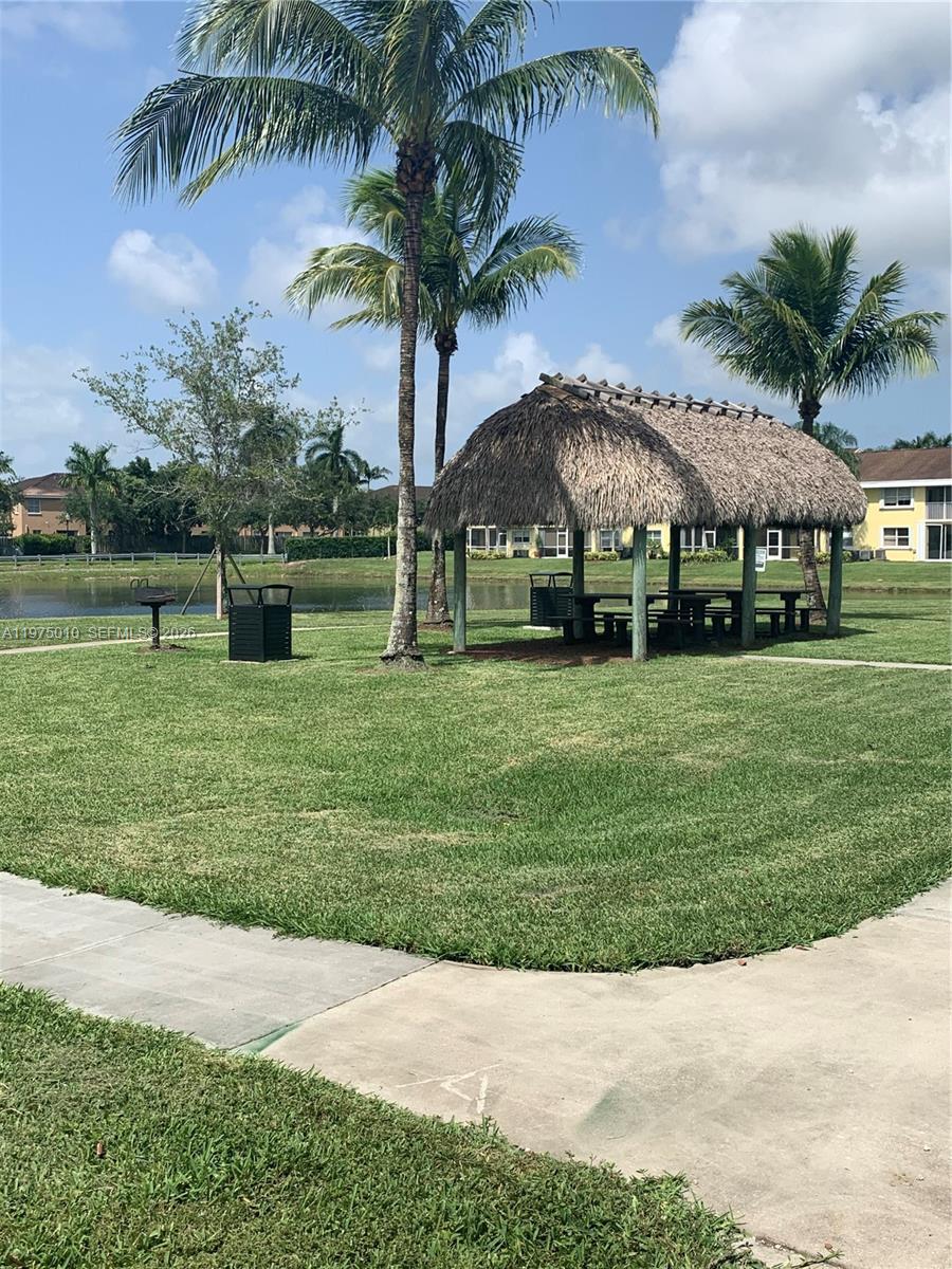 2211 Southeast 23rd Road, Unit 2211 Homestead, FL 33035 - Photo 25 of 39 a garden with palm trees