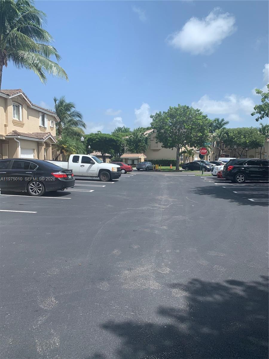 2211 Southeast 23rd Road, Unit 2211 Homestead, FL 33035 - Photo 39 of 39 a view of a street with a cars parked in front of it