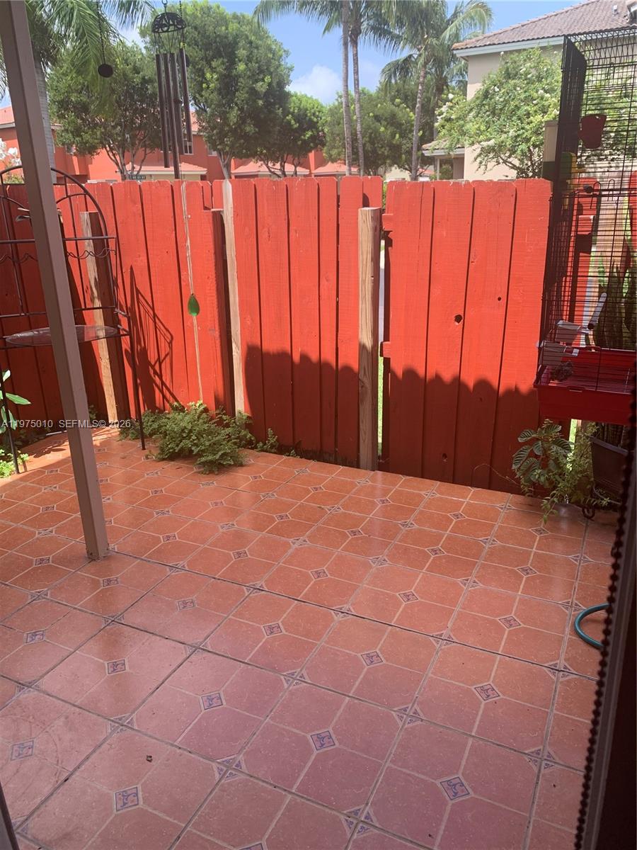 2211 Southeast 23rd Road, Unit 2211 Homestead, FL 33035 - Photo 6 of 39 a view of a backyard with lawn chairs potted plants