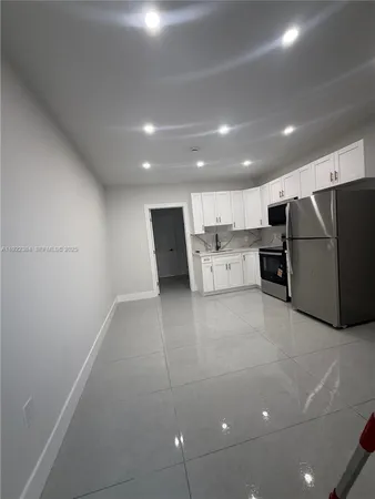 a view of kitchen with refrigerator sink and microwave