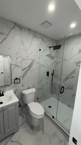 a bathroom with a toilet sink and shower