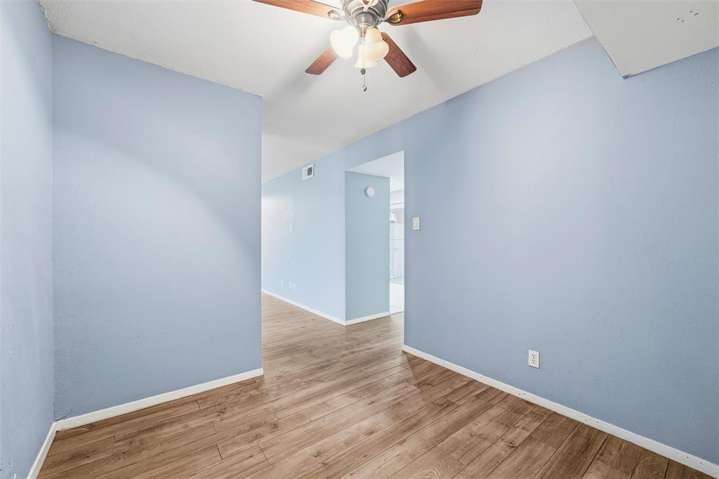 5604 Boca Raton Boulevard, Unit 248 Fort Worth, TX 76112 - Photo 12 of 25 a view of an empty room with window and wooden floor