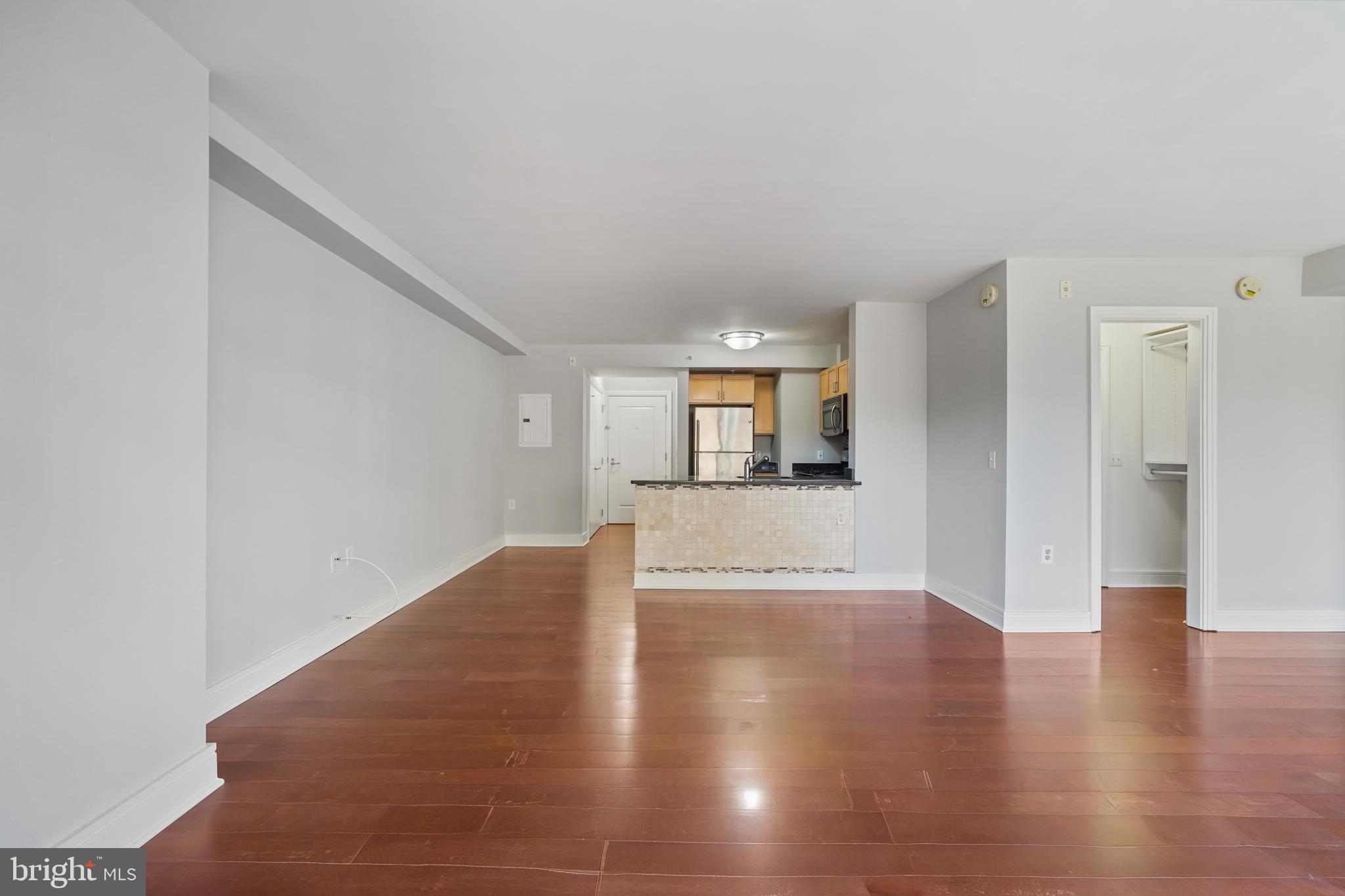 800 4th Street Southwest, Unit N111 Washington, DC 20024 - Photo 16 of 27 a view of a big room with wooden floor and a kitchen