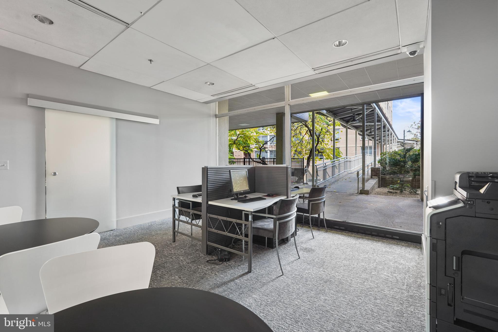 800 4th Street Southwest, Unit N111 Washington, DC 20024 - Photo 23 of 27 a living room with furniture a large window and a table